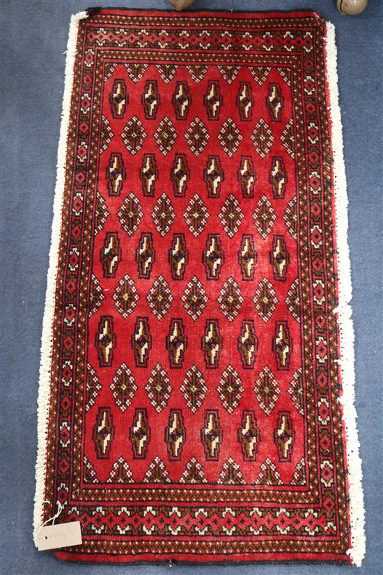A Bokhara style mat, 102 x 49cm